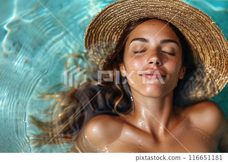 Relaxed Woman in Pool. A woman in a straw hat enjoys relaxing in a pool Relaxed Woman in Pool. A woman in a straw hat enjoys relaxing in a pool 116651181