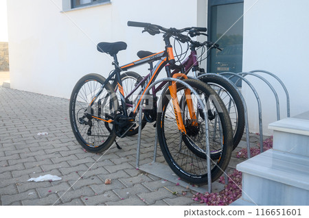 Gaziveren Cyprus 15.06.2024 - bicycles in the parking lot near the entrance 116651601