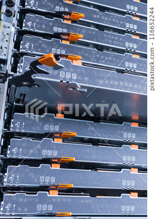 server rack with open tray filled with hard disk array used for providing data cloud services 116652244