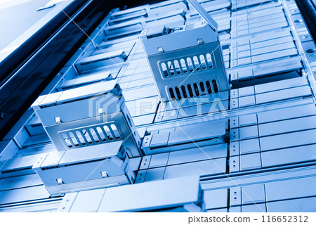 detail of data center with some of hard drive bays open 116652312