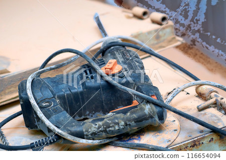 Electric rotary hammer drill on metal surface.Construction 116654094