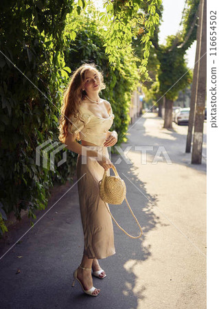 beautiful teenage girl in a silk skirt and a corset in the old money style strolls through the city beautiful teenage girl in a silk skirt and a corset in the old money style strolls through the city 116654502