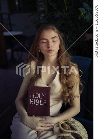 beautiful teenage girl in a peach fluffy suit with a waistcoat in the old money style reads the Holy Bible and prays beautiful teenage girl in a peach fluffy suit with a waistcoat in the old money style reads the Holy Bible and prays 116655076