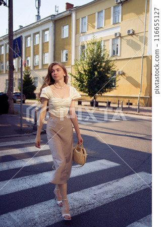 beautiful teenage girl in a silk skirt and a corset in the old money style strolls through the city beautiful teenage girl in a silk skirt and a corset in the old money style strolls through the city 116655127