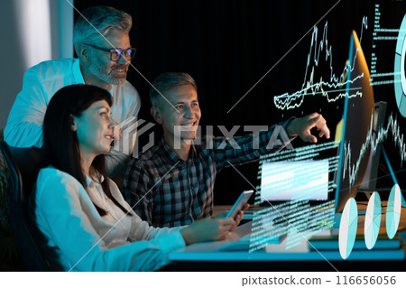 Team Analyzing Data on Digital Display in a Modern Office Team Analyzing Data on Digital Display in a Modern Office 116656056
