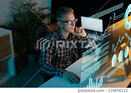 Businessman Analyzing Data on Holographic Screen in Modern Office Setting Businessman Analyzing Data on Holographic Screen in Modern Office Setting 116656132