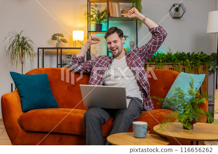 Surprised amazed man use laptop receive good news victory celebrate lottery jackpot casino game win Surprised amazed man use laptop receive good news victory celebrate lottery jackpot casino game win 116656262