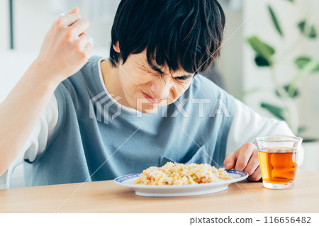 young man eating fried rice 116656482