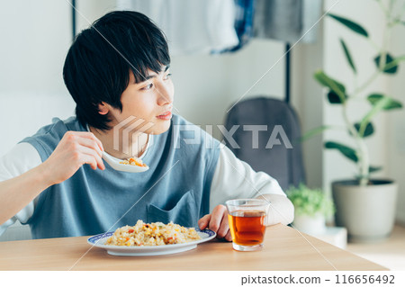 young man eating fried rice - Stock Photo [116656492] - PIXTA