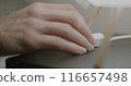 Close-up of female hand turning off light touching lamp switch on bedside table and sleeping at night. Time to sleep concept. 116657498