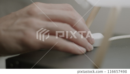 Close-up of female hand turning off light touching lamp switch on bedside table and sleeping at night. Time to sleep concept. 116657498