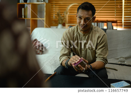 Fortune teller forecasting predicting future for man client. Forecasting and divination concept Fortune teller forecasting predicting future for man client. Forecasting and divination concept 116657749