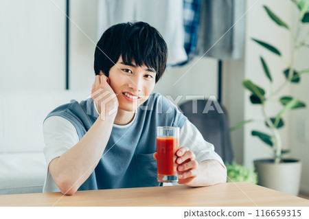 一個年輕人喝蔬菜汁 一個年輕人喝蔬菜汁 116659315