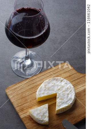 Relax with a glass of red wine and some Camembert cheese as a snack. Relax with a glass of red wine and some Camembert cheese as a snack. 116661042