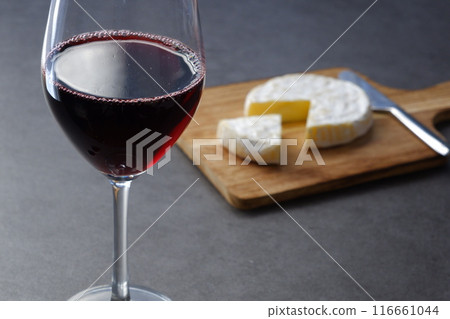Relax with a glass of red wine and some Camembert cheese as a snack. Relax with a glass of red wine and some Camembert cheese as a snack. 116661044