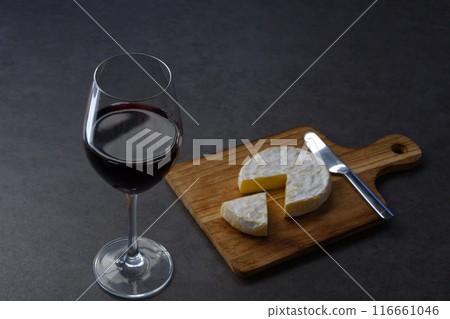 Relax with a glass of red wine and some Camembert cheese as a snack. Relax with a glass of red wine and some Camembert cheese as a snack. 116661046