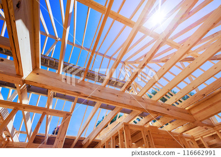 Wooden roof beam is constructed from frames of trusses rafters 116662991