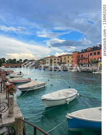 Sunset view of main canal in Italian town Peschiera del Garda. Sunset view of main canal in Italian town Peschiera del Garda. 116663203