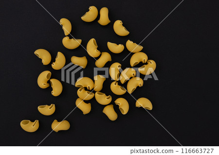 uncooked pipe rigate pasta isolated on black background uncooked pipe rigate pasta isolated on black background 116663727