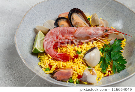 seafood paella, on a plate, traditional Spanish dish, top view, no people, 116664049