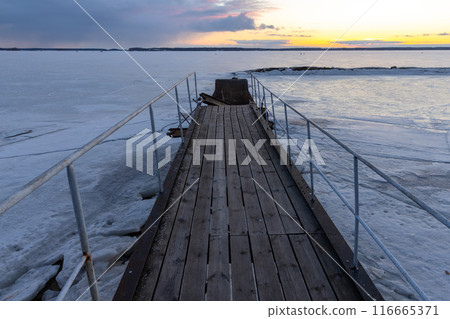 Old pier with wooden flooring is under sunset sky, perspective view Old pier with wooden flooring is under sunset sky, perspective view 116665371