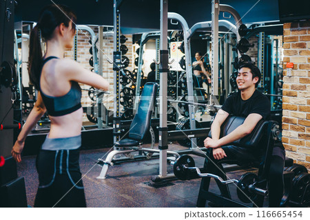 Men and women training at the fitness gym 116665454