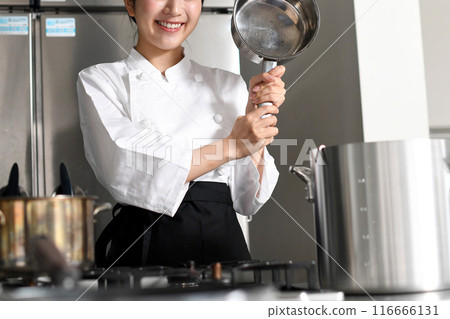 Young asian female chef cooking in a pot 116666131