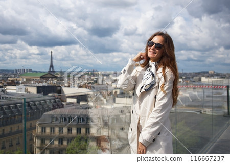 Girl on the roof of a Parisian building overlooking the city skyline 116667237