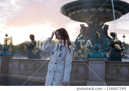 A girl poses in front of a fountain on Place de la Concorde in Paris 116667240