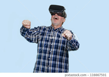 Portrait of elder man driving a virtual imaginary steering wheel. Isolated on blue background. Portrait of elder man driving a virtual imaginary steering wheel. Isolated on blue background. 116667501