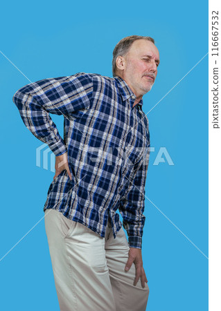 Senior aged caucasian man is having a backache. Isolated on blue. Senior aged caucasian man is having a backache. Isolated on blue. 116667532