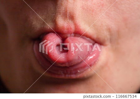 Female tongue. Close-up Of A Woman's Face Showing Her Clean Tongue 116667534