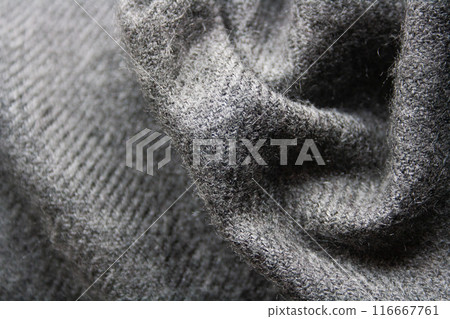 Knitted fabric in grey tones. Waved background. 116667761