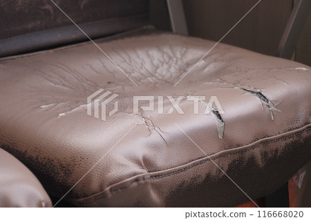 damage Leather with a cracked texture on a sofa . damage Leather with a cracked texture on a sofa . 116668020