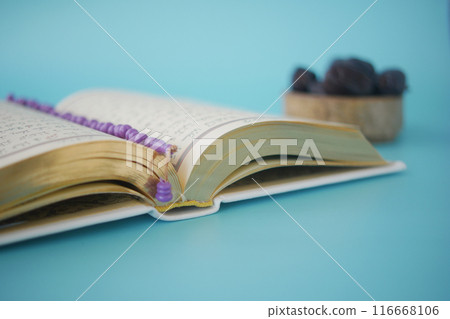 Holy book Quran and rosary on table, close up. Holy book Quran and rosary on table, close up. 116668106