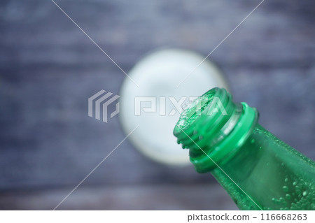 pouring soft drinks from bottle in a glass  116668263