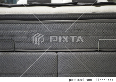 Detailed closeup view of gray mattress showcasing knitted design, offering comfort and style Detailed closeup view of gray mattress showcasing knitted design, offering comfort and style 116668333