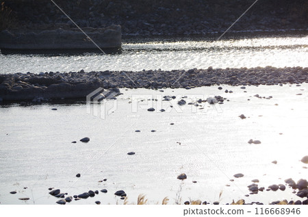 Morning sun on the river surface and silhouettes of stones Morning sun on the river surface and silhouettes of stones 116668946