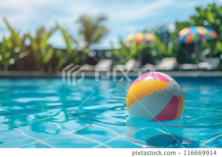A beach ball is floating in a pool 116669914
