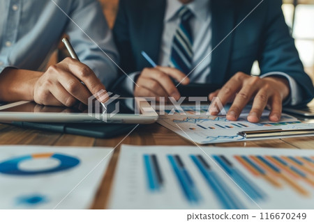 Two business people working together at meeting room Two business people working together at meeting room 116670249