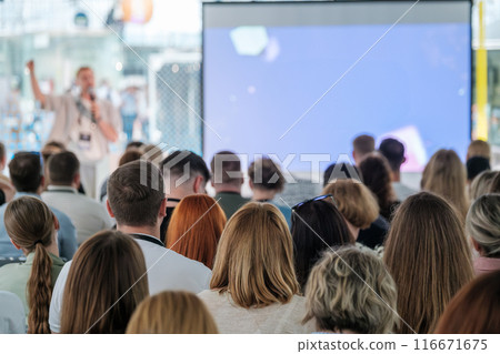 Speaker addressing an audience at a conference Speaker addressing an audience at a conference 116671675