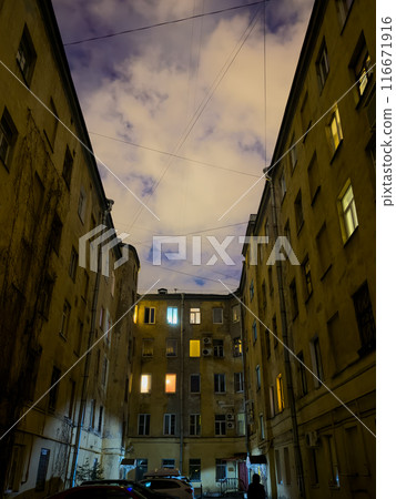 Night view of old residential buildings with illuminated windows Night view of old residential buildings with illuminated windows 116671916