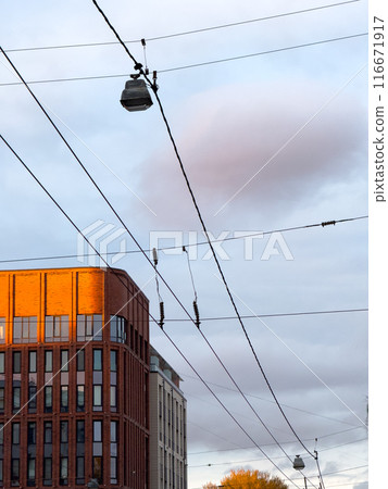 Urban setting with power lines and modern building Urban setting with power lines and modern building 116671917