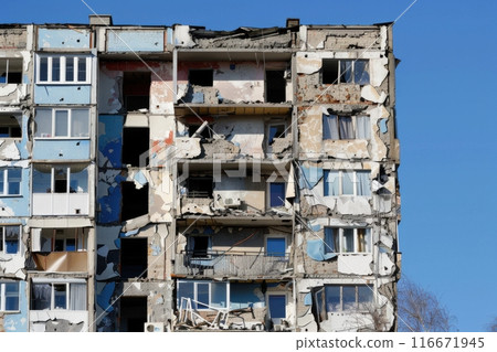 Damaged apartment building from conflict with blue sky Damaged apartment building from conflict with blue sky 116671945