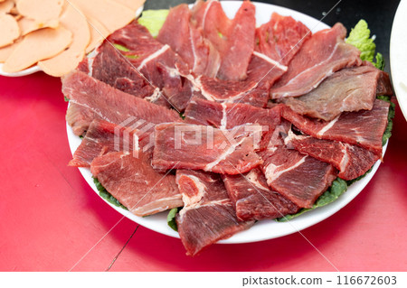 Serving of fresh raw yak meat as one of the ingredients in Tibetan hotpot or steamboat Serving of fresh raw yak meat as one of the ingredients in Tibetan hotpot or steamboat 116672603