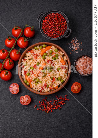 Delicious boiled rice with vegetables carrots, peas and peppers 116677337