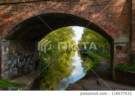 Old bridge over a stream in Europe 116677632