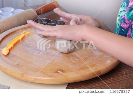 Young teenage girl molding ball of clay at home. Hobbies and tools. Creativity for children, education. Young teenage girl molding ball of clay at home. Hobbies and tools. Creativity for children, education. 116678857