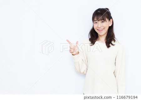 A woman who raises her index finger with a smile 116679194