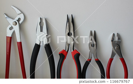 Different Types Of Pliers With Plastic Handles Arranged By Size Isolated On White Background 116679767